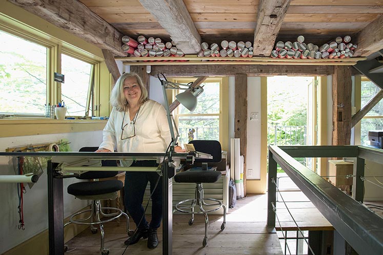 Mono landscape architect Karen Rosenbrock has plied her trade since 1995 in a three-storey former carriage house and barn she restored after moving to the property in 1990. Shown here is Karen in her main-level workspace, and a charming fern and salamander mosaic on the floor of the lower level. Photo by Pete Paterson.