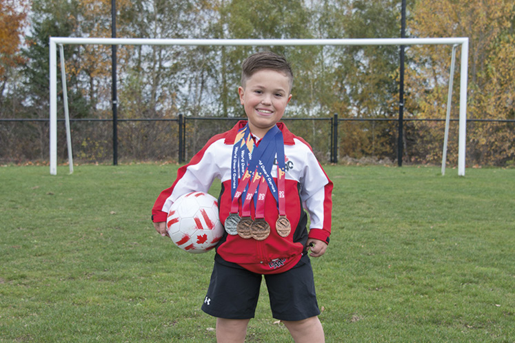 McHughan displays his medals won at the World Dwarf Games in Germany.