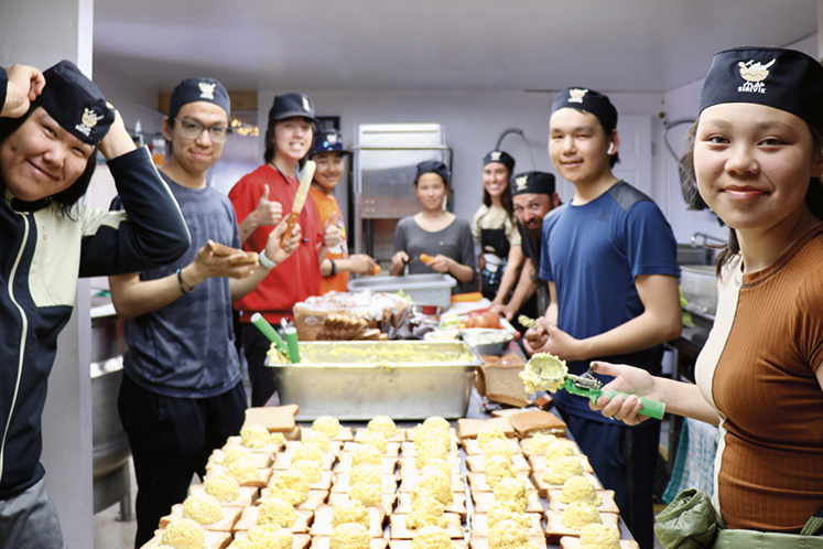 Staff and volunteers at Sirivik, a locally run food centre, make picnic lunches as part of a youth-ledhealthy lifestyle program.